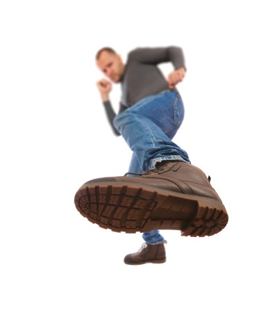 The man is kicking. Foot with a shoe close-up. a man draws an opponent with a boot.の写真素材