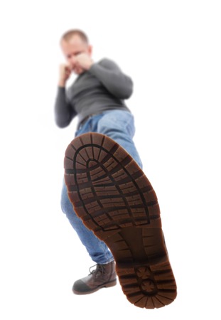 The man is kicking. Foot with a shoe close-up. A man in a battle rack strikes his foot.の写真素材