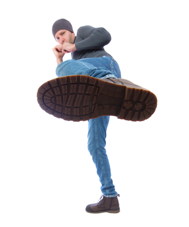 The man is kicking. Foot with a shoe close-up. a man in a cap hits a boot