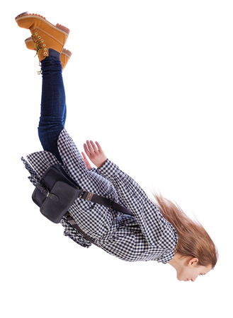 Side view of woman in zero gravity or a fall. girl is flying, falling or floating in the air. Side view people collection. side view of person. Isolated over white background. A girl with fluttering hair falls and looks down.の写真素材