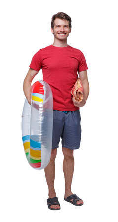 Front view of a man in shorts with an inflatable circle. guy on the beach. Rear view people collection.  backside view of person.  Isolated over white background. Beach shorts ready to go swimmingの写真素材