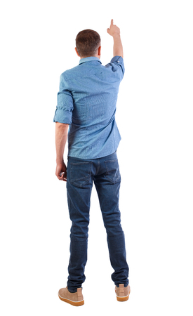 Back view of a man in jeans points his hand upwards. Rear view people collection.  backside view of person.  Isolated over white background. Man in yellow boots in a short sleeve shirtの写真素材