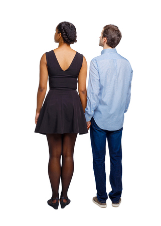 Back view of the interracial couple. friendly girl and guy together. Rear view people collection.  backside view of person.  Isolated over white background.の写真素材