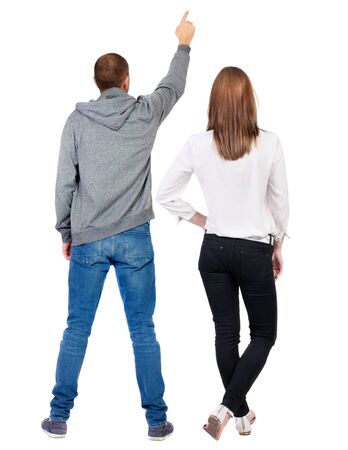 Back view of a stylish couple pointing. beautiful friendly girl and guy together. Rear view people collection. backside view of person. Isolated over white background.の写真素材