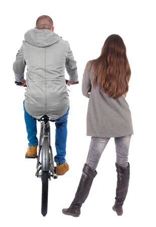 Back view of couple in winter jacket. man on a bicycle and a woman. Rear view people collection. backside view of person. Isolated over white background.の写真素材