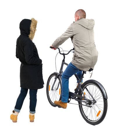 Back view of couple in winter jacket. man on a bicycle and a woman. Rear view people collection. backside view of person. Isolated over white background.の写真素材