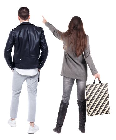 back view of couple with shopping bags. backside view of person. Rear view people collection. Isolated over white background.の写真素材