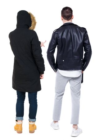 Back view of couple couple in winter jackets pointing. beautiful friendly girl and guy together. Rear view people collection. backside view of person. Isolated over white background.の写真素材