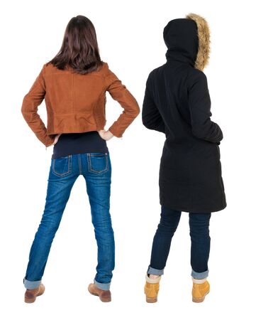 Back view of couple couple in winter jackets pointing. beautiful friendly girl and guy together. Rear view people collection. backside view of person. Isolated over white background.の写真素材
