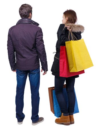 back view of couple with shopping bags. backside view of person. Rear view people collection. Isolated over white background.の写真素材