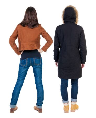 Back view of couple couple in winter jackets pointing. beautiful friendly girl and guy together. Rear view people collection. backside view of person. Isolated over white background.の写真素材