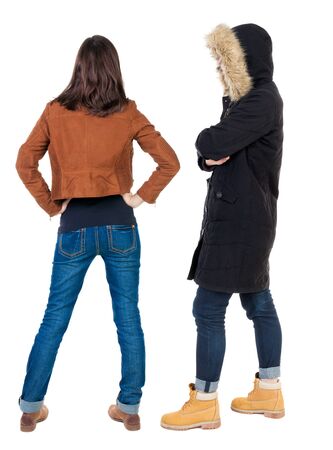 Back view of couple couple in winter jackets pointing. beautiful friendly girl and guy together. Rear view people collection. backside view of person. Isolated over white background.の写真素材