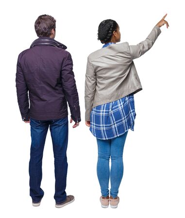 Back view of couple couple in winter jackets pointing. beautiful friendly girl and guy together. Rear view people collection. backside view of person. Isolated over white background.の写真素材