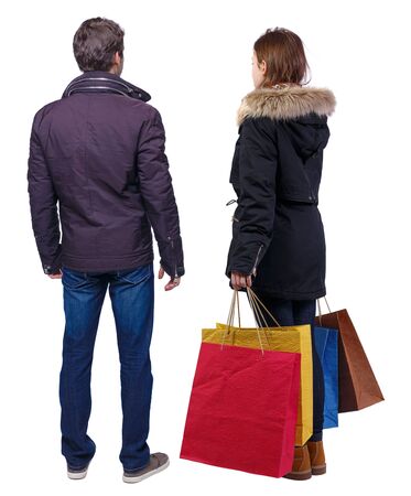 back view of couple with shopping bags. backside view of person. Rear view people collection. Isolated over white background.の写真素材