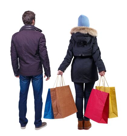 back view of couple with shopping bags. backside view of person. Rear view people collection. Isolated over white background.の写真素材