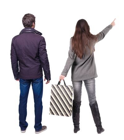 back view of couple with shopping bags. backside view of person. Rear view people collection. Isolated over white background.の写真素材