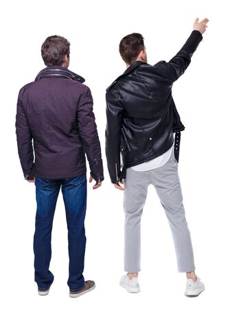 Back view of couple couple in winter jackets pointing. beautiful friendly girl and guy together. Rear view people collection. backside view of person. Isolated over white background.の写真素材