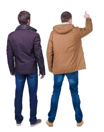 Back view of couple couple in winter jackets pointing. beautiful friendly girl and guy together. Rear view people collection. backside view of person. Isolated over white background.の写真素材