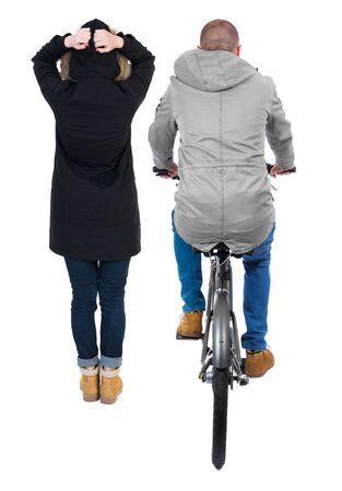 Back view of couple in winter jacket. man on a bicycle and a woman. Rear view people collection. backside view of person. Isolated over white background.の写真素材