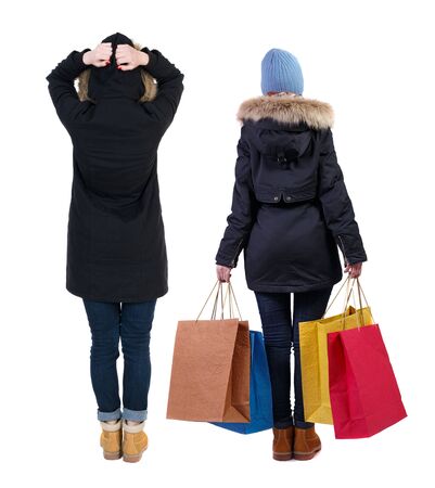 back view of couple with shopping bags. backside view of person. Rear view people collection. Isolated over white background.の写真素材