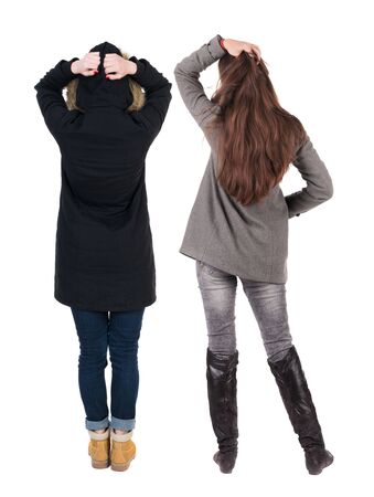 Back view of couple couple in winter jackets pointing. beautiful friendly girl and guy together. Rear view people collection. backside view of person. Isolated over white background.の写真素材
