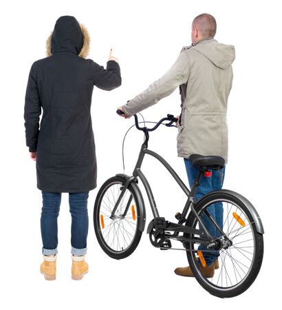 Back view of couple in winter jacket. man on a bicycle and a woman. Rear view people collection. backside view of person. Isolated over white background.の写真素材