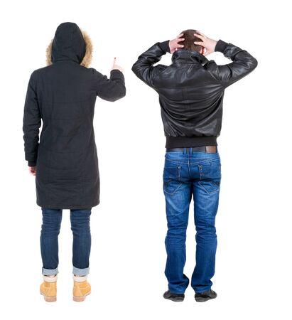 Back view of couple couple in winter jackets pointing. beautiful friendly girl and guy together. Rear view people collection. backside view of person. Isolated over white background.の写真素材