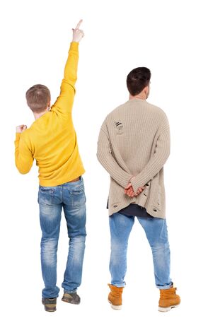 Back view of couple couple in sweater pointing. beautiful friendly girl and guy together. Rear view people collection. backside view of person. Isolated over white background.の写真素材
