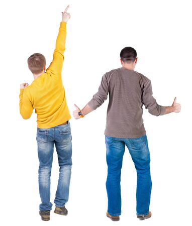 Back view of couple couple in sweater pointing. beautiful friendly girl and guy together. Rear view people collection. backside view of person. Isolated over white background.の写真素材
