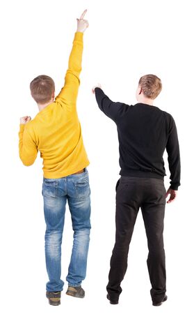 Back view of couple couple in sweater pointing. beautiful friendly girl and guy together. Rear view people collection. backside view of person. Isolated over white background.の写真素材