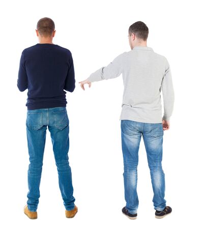Back view of couple couple in sweater pointing. beautiful friendly girl and guy together. Rear view people collection. backside view of person. Isolated over white background.の写真素材