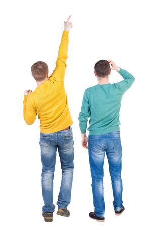 Back view of couple couple in sweater pointing. beautiful friendly girl and guy together. Rear view people collection. backside view of person. Isolated over white background.の写真素材