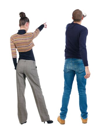 Back view of couple couple in sweater pointing. beautiful friendly girl and guy together. Rear view people collection. backside view of person. Isolated over white background.の写真素材