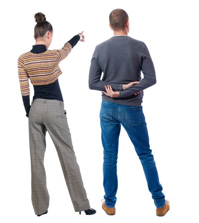 Back view of couple couple in sweater pointing. beautiful friendly girl and guy together. Rear view people collection. backside view of person. Isolated over white background.の写真素材