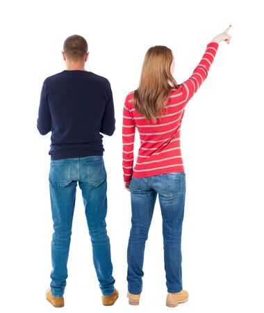 Back view of couple couple in sweater pointing. beautiful friendly girl and guy together. Rear view people collection. backside view of person. Isolated over white background.の写真素材