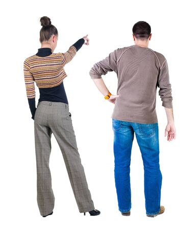 Back view of couple couple in sweater pointing. beautiful friendly girl and guy together. Rear view people collection. backside view of person. Isolated over white background.の写真素材