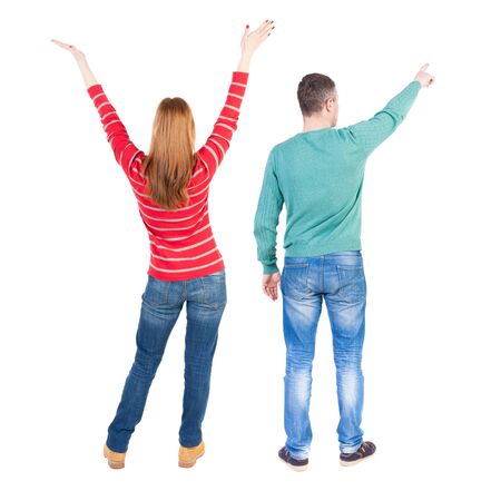 Back view of couple couple in sweater pointing. beautiful friendly girl and guy together. Rear view people collection. backside view of person. Isolated over white background.の写真素材