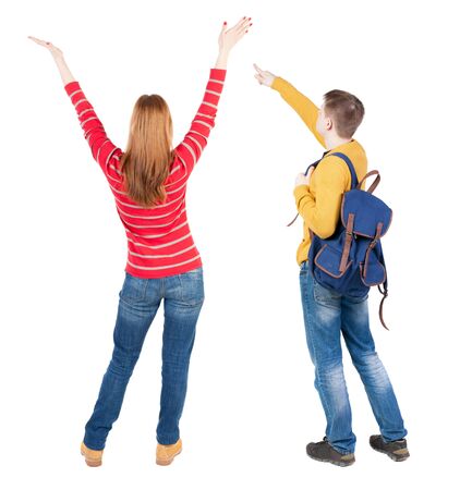 Back view of couple couple in sweater pointing. beautiful friendly girl and guy together. Rear view people collection. backside view of person. Isolated over white background.の写真素材