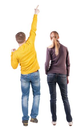 Back view of couple couple in sweater pointing. beautiful friendly girl and guy together. Rear view people collection. backside view of person. Isolated over white background.の写真素材