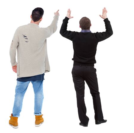 Back view of couple couple in sweater pointing. beautiful friendly girl and guy together. Rear view people collection. backside view of person. Isolated over white background.の写真素材