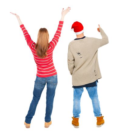 Back view of couple couple in sweater showing thumbs up. beautiful friendly girl and guy together. Rear view people collection. backside view of person. Isolated over white background.の写真素材