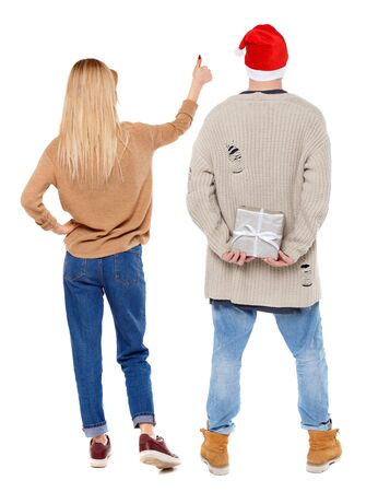 Back view of couple couple in sweater showing thumbs up. beautiful friendly girl and guy together. Rear view people collection. backside view of person. Isolated over white background.の写真素材
