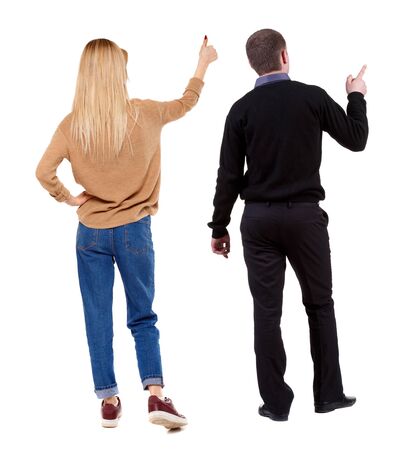 Back view of couple couple in sweater pointing. beautiful friendly girl and guy together. Rear view people collection. backside view of person. Isolated over white background.の写真素材