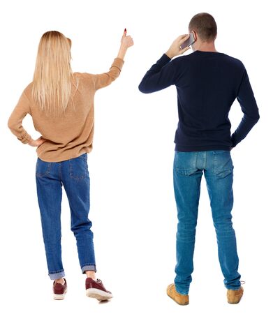 Back view of couple in sweater photographed on a mobile phone. beautiful friendly girl and guy together. Rear view people collection. backside view of person. Isolated over white background.の写真素材