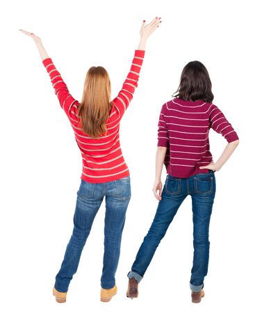 Back view of couple couple in sweater pointing. beautiful friendly girl and guy together. Rear view people collection. backside view of person. Isolated over white background.の写真素材