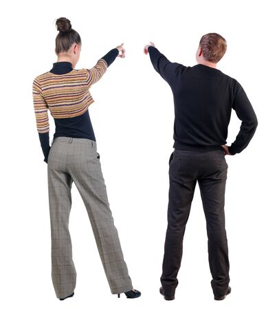 Back view of couple couple in sweater pointing. beautiful friendly girl and guy together. Rear view people collection. backside view of person. Isolated over white background.の写真素材