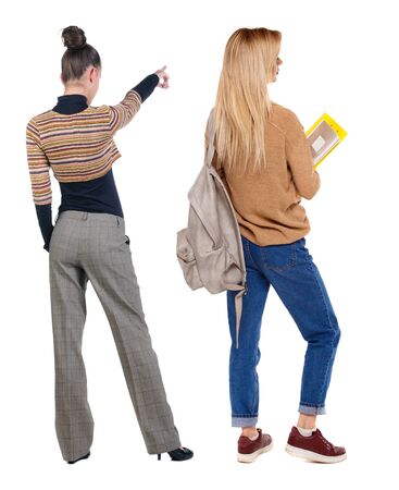 Back view of two pointing young girl in sweater. Rear view people collection. backside view of person. beautiful woman friends showing gesture. Rear view. Isolated over white background.の写真素材