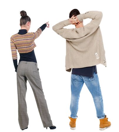Back view of couple couple in sweater pointing. beautiful friendly girl and guy together. Rear view people collection. backside view of person. Isolated over white background.の写真素材