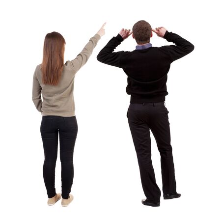 Back view of couple couple in sweater pointing. beautiful friendly girl and guy together. Rear view people collection. backside view of person. Isolated over white background.の写真素材