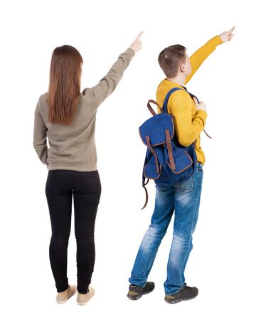 Back view of couple couple in sweater pointing. beautiful friendly girl and guy together. Rear view people collection. backside view of person. Isolated over white background.の写真素材